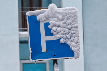 Car parking sign covered with snow. Winterの写真素材