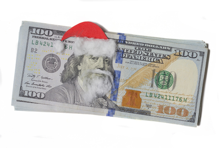 Benjamin Franklin in a Santa Claus hat on a banknote isolated a white backgroundの写真素材