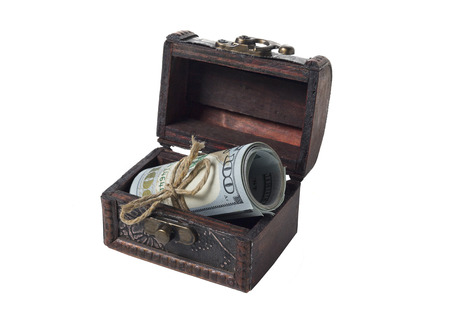 Dollars in a scroll in a retro chest isolated on a white background