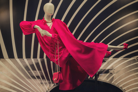 Dummy in a magnificent red dress in a show-window of shop. Fashionの写真素材