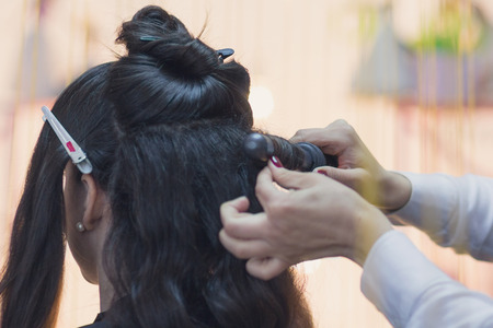 Hands of the hairdresser making hairstyle. Barbershop