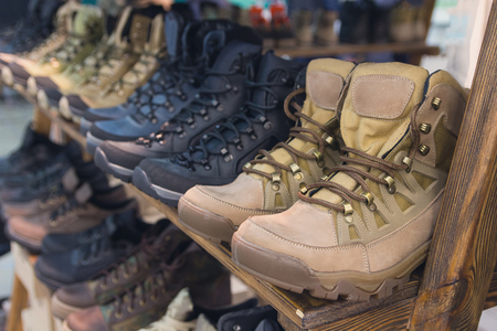 Army boots are in line at the store counter. Shoesの写真素材