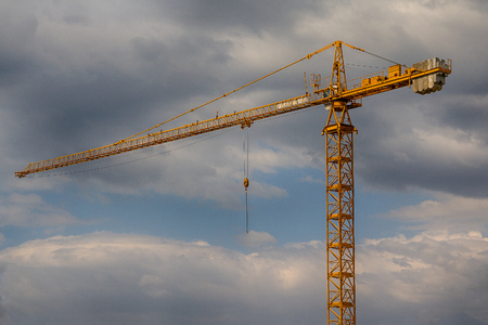 Yellow construction crane against the background of the sky. Constructionの写真素材