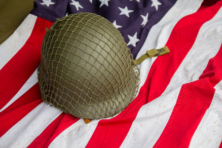 Soldier's helmet and the times of the Second World War and the US flag.