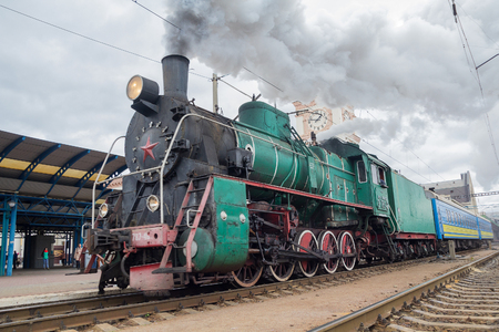 Kiev, Ukraine - October 14, 2017: Departure of a retro locomotive with Soviet symbols from the central stationのeditorial素材