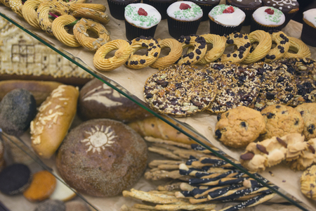 Fresh bread and various buns on the display. Bakeryの写真素材