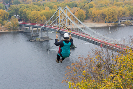 Man descends on the cable car through the river. Sportの写真素材