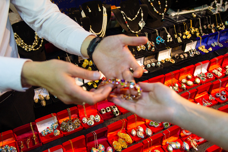 Counter with jewelry and arms buyer and seller. Saleの写真素材
