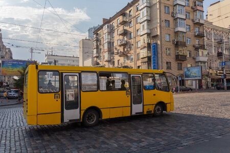 Kiev, Ukraine - Auguat 30, 2018: Yellow ibus is traveling along a route on a city street