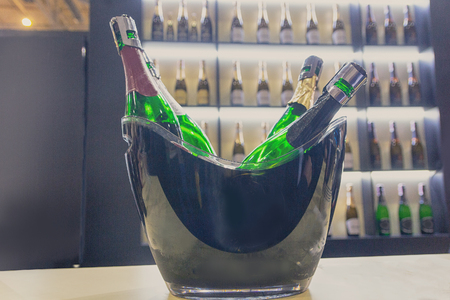 Bottles with sparkling wine on a counter of wine shop. Drinksの写真素材