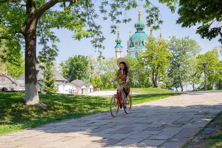 Kiev, Ukraine - May 12, 2018: Girl in retro clothes participating in the êetro èicycle êace against the background of St. Andrews Churchのeditorial素材