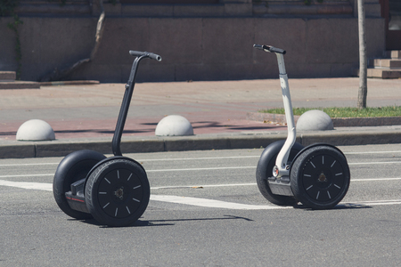 Two scooter stand on a city street. Transportの写真素材