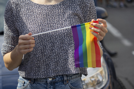 Rainbow flag in the hands of a girl - a member of the community lgbt. Charactersの写真素材
