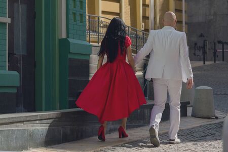 Couple walking hand in hand in urban environment