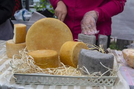 Cheese in a wicker basket on the market counter. Foodの写真素材