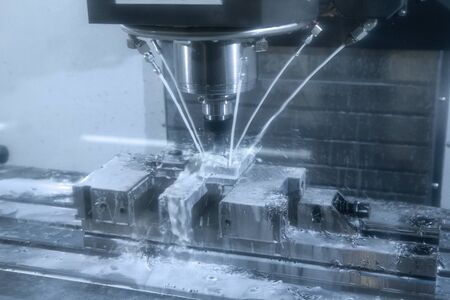 CNC milling machine cutting the tire mold part with the solid ball end-mill tool and coolant fluid