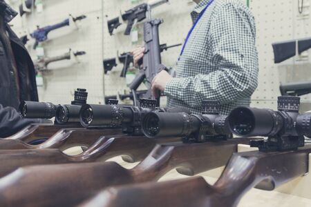 Buyer and seller at the counter of a gun shop. Weaponsの写真素材