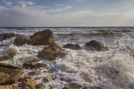 Waves stumble across rocks on the coast. Nature