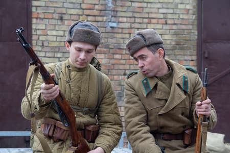 Kiev, Ukraine - May 9, 2018: Young and elderly men in the uniform of the Red Army on the historical reconstruction of the anniversary of the victory in World War IIのeditorial素材