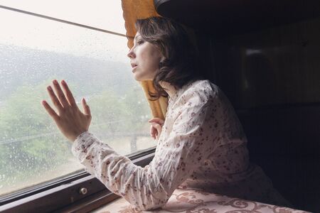 Pensive girl at the train window. A train