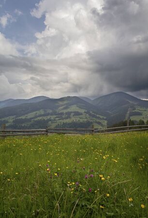Village landscape with a wooden fence in the foreground. Carpathiansの写真素材