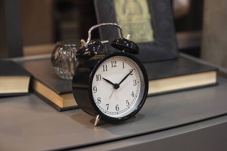 Alarm clock on the table in the bedroom. Interiorsの写真素材