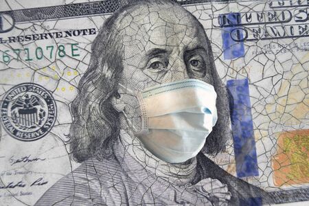 100 dollar banknote with a face mask. World crisisの写真素材