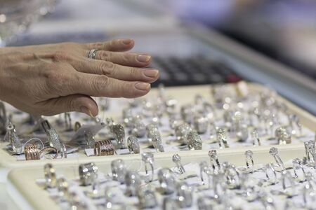 Womans hand and counter with jewelry. Saleの写真素材
