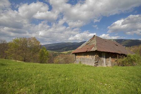 Household with an old wooden barn in the Carpathian mountainsの写真素材