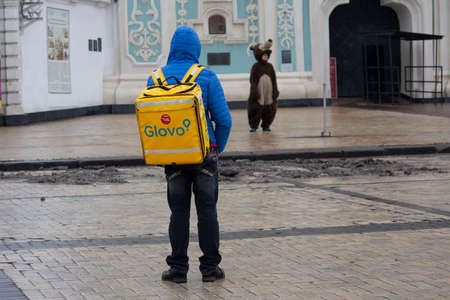Kiev, Ukraine - January 31, 2020: Mens working as a delivery courier and animator in a suit in Sofia Squareのeditorial素材