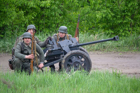 Kiev, Ukraine - May 09, 2019: Wehrmacht soldiers with anti-tank guns. Historical Reconstruction in an anniversary of the victory in World War IIのeditorial素材