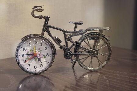 Clock and bicycle of the table. Interior
