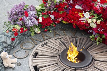 Flowers child's toy for the monument Eternal fire to the unknown soldier. Kiev, Ukraineの写真素材