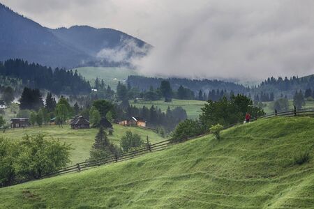Views of the mountains and village in the morning fog. Carpathians, Ukraineの写真素材