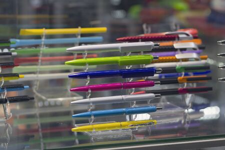 Multicolored plastic writing pens on the counterの写真素材