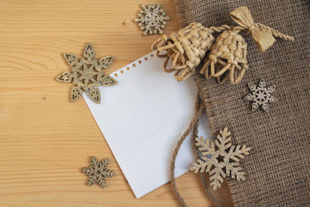 Snowflakes and bells on a wooden surface. Christmas decorationsの写真素材