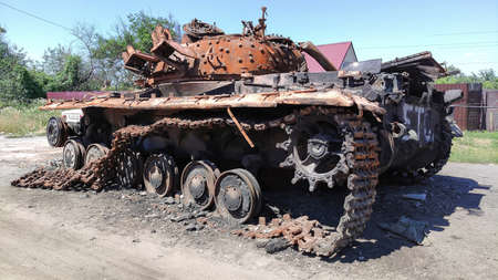 Destroyed tank on the street of the village of Ukraineの写真素材