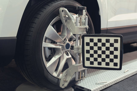 Wheel alignment equipment on a car wheel in a repair station. Industryの写真素材