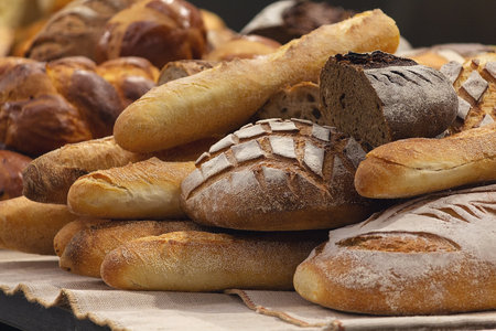 Different kinds of fresh bread on the bakery counter. Foodの写真素材