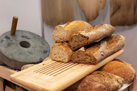 Retro mechanical stone mill and craft bakery bread. Foodの写真素材