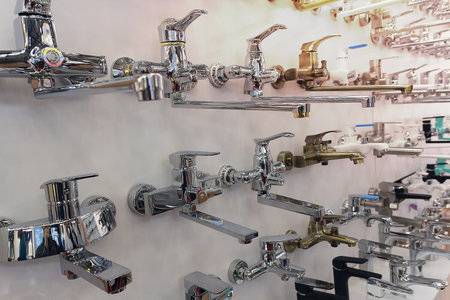 Mixer for bathtub, washbasin. Plumbing in a hardware store. sink with tap. Detail of corner shower with wall mount for shower. Plumbing industryの写真素材