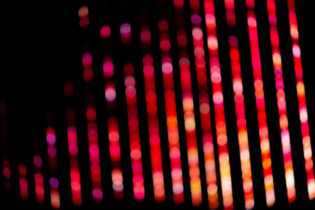 Blurred background of colorful red bokeh lneon lights