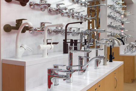 Mixers for kitchen, bathtub, washbasin. Plumbing in a hardware storeの写真素材