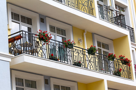 Flowerpots with flowers on the balcony of a new house. Architectureの写真素材