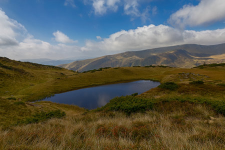 Carpathian countryside scenery. Mountain landscape of Ukraine with grassy meadows and mountain lakeの写真素材