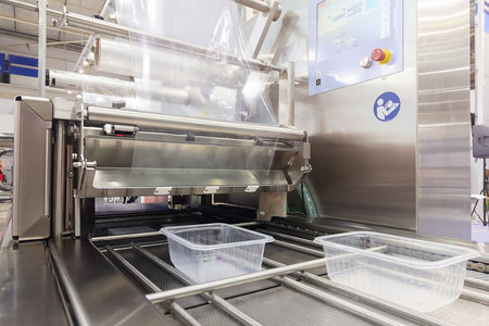 Automatic industrial machine for plastic packaging food. shaft of an automated packaging line with...
