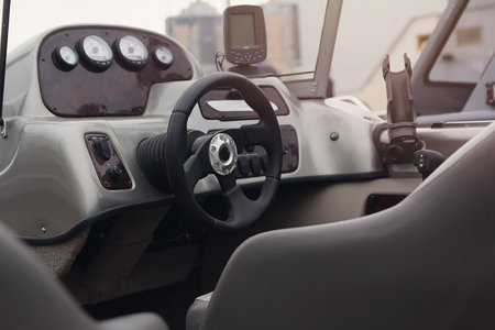 Instrument panel and steering wheel of a motor boat. Transport
