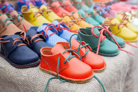 Rows of colorful children's shoes on sale, Comfortable shoesの写真素材