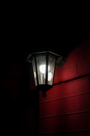 Modern LED lamp in a retro lantern on an evening street. Eco conceptの写真素材