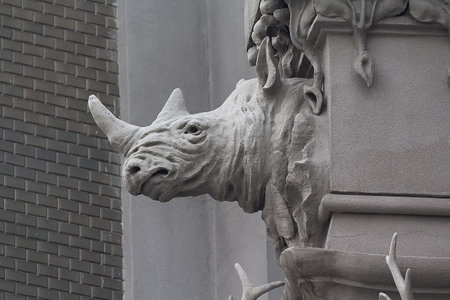 A close up on rhinos on the side wall of House with Chimaeras/Horodecki House build in Art Nouveau style in Kiev, Ukraine. House is decorated with various animals like snakes, frogs, deer, elephantsの写真素材